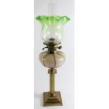 An Art Nouveau glass and brass oil lamp, the iridescent bowl in the manner of Loetz, reeded column