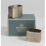 Graham Watling (1930-1996), a pair of silver napkin rings of textured rounded rectangular form,