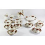 A Royal Albert Country Roses six piece tea service to include, teacups 8cm, saucers 14cm, sandwich
