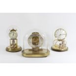 Three "Kundo" German made anniversary mantle clocks, mid 20th Century, brass with glass dome's -