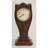 An Art Nouveau mantle clock with a carved overcoated mahogany case in a "Lyre form" enameled white