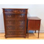 A mahogany inlaid chest of drawers, comprising of five walnut veneered graduated drawers on ball