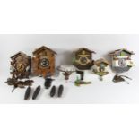 A collection of five black forest cuckoo clocks and chalet stamped Germany