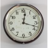 A Smiths 8 day wall clock, Bakelite case. Having a hinged 16cm chrome bezel and painted white dial.