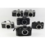 A collection of Nikon 35mm film cameras. to include a Nikon FE Chrome, a Nikon FE Black, Nikon F-