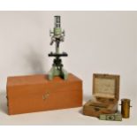 A Regent microscope, boxed, together with a German made unbranded brass microscope, three slides,