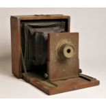 A 3 x 4 field box camera, unbranded, together with a collection of glass 3 x 4 plate negatives,