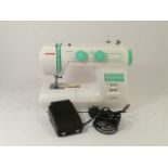 A Janome sewing machine model number 2200XT complete with foot pedal and power lead (boxed).