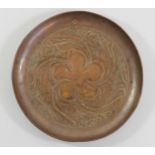 Keswick School of Industrial Arts, an Arts & Crafts circular copper tray with repousse decoration of