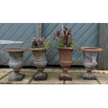 A set of four cast iron campagna garden urns