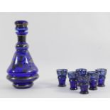 A cobalt drinks decanter with a set of six liqueur glasses, Bristol blue with silver overlay