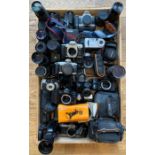 A collection of cameras, both film and digital, along with photography and camera accessories, to