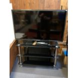 A Blaupunkt (model B40U133T) 49 inch KLED TV, remote and manual, together with a two tier glass