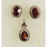 A 9ct gold and garnet pendant and matching ear studs, 1.9gm