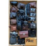 A collection of cameras, both film and digital, along with photography and camera accessories, to