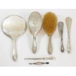 A silver hand mirror, Birmingham 1917, two hair brushes and other silver