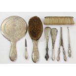 A silver hand mirror and two brushes, London 1909 and other silver