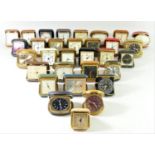 A large collection of mid 20th century and later travel alarm clocks, makers to include Swiza,