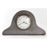 English Pewter, a hammered pewter Napoleon's Hat mantel clock with white enamel dial, French