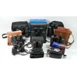 Nine pairs of binoculars, cased and loose, to include brands such as Praktica, tasco and others