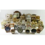 A large collection of 1950s and later alarm clocks, desk clocks, carriage and anniversary clocks (