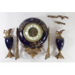 A French late 19th century porcelain and ormolu clock and garniture having enameled dial, Arabic