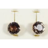 A pair of 9ct gold mounted smokey quartz ear studs, diameter 9mm, 2.9gm