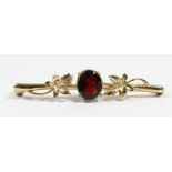 A 9ct gold and garnet bar brooch, 50mm, 3.6gm