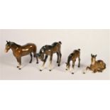 A group of four Beswick chestnut horses and foals, to include model 516, a lying down foal (4)