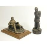 A bronzed figure 'fireman at rest', by A.Miller 1981, signed and dated, on a wooden plinth, together