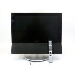 A Bang and Olufsen BeoVision 6 television, with motorised table stand and 22inch screen, including a