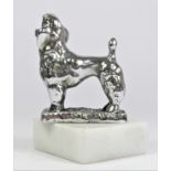 A chrome car mascot in the form of Poodle mounted on a white onyx base, stamped Desmo, 13cm.