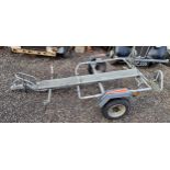 An Erde galvanised single motorcycle trailer with lights.