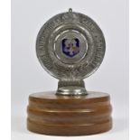 A RAC associate, Cheshire Automobile Club car badge number F70864, mounted on a wooden base.