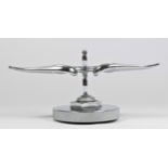 A chrome car mascot in the form of a flying winged Bentley mounted on a radiator cap, 11cm.