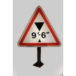 A triangular illuminated road warning sign, depicting smaller than 9 ft 6 ", 100 x 69 cm