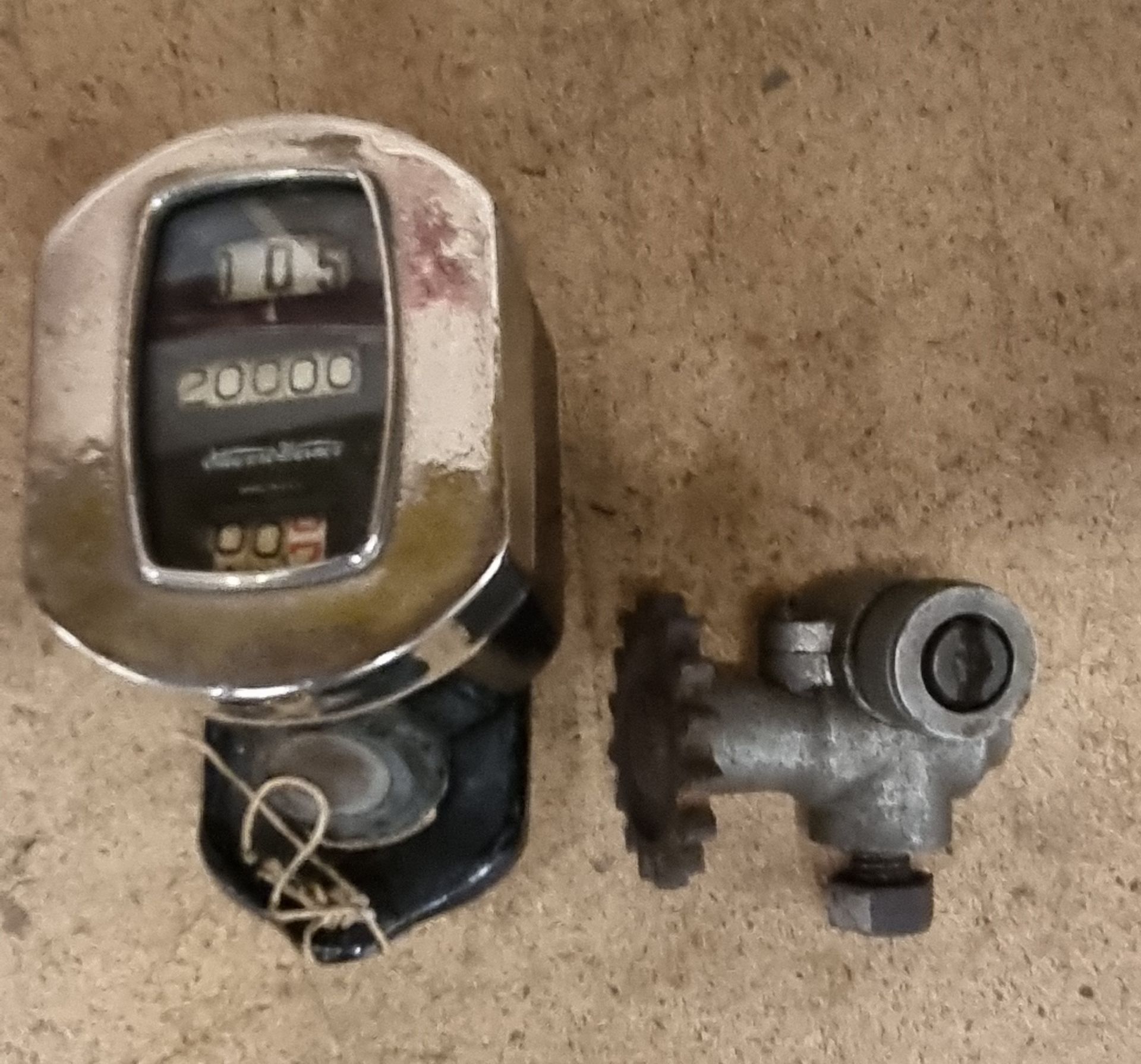 A rare Stewart Warner digital motorcycle speedo, together with a drive mechanism.