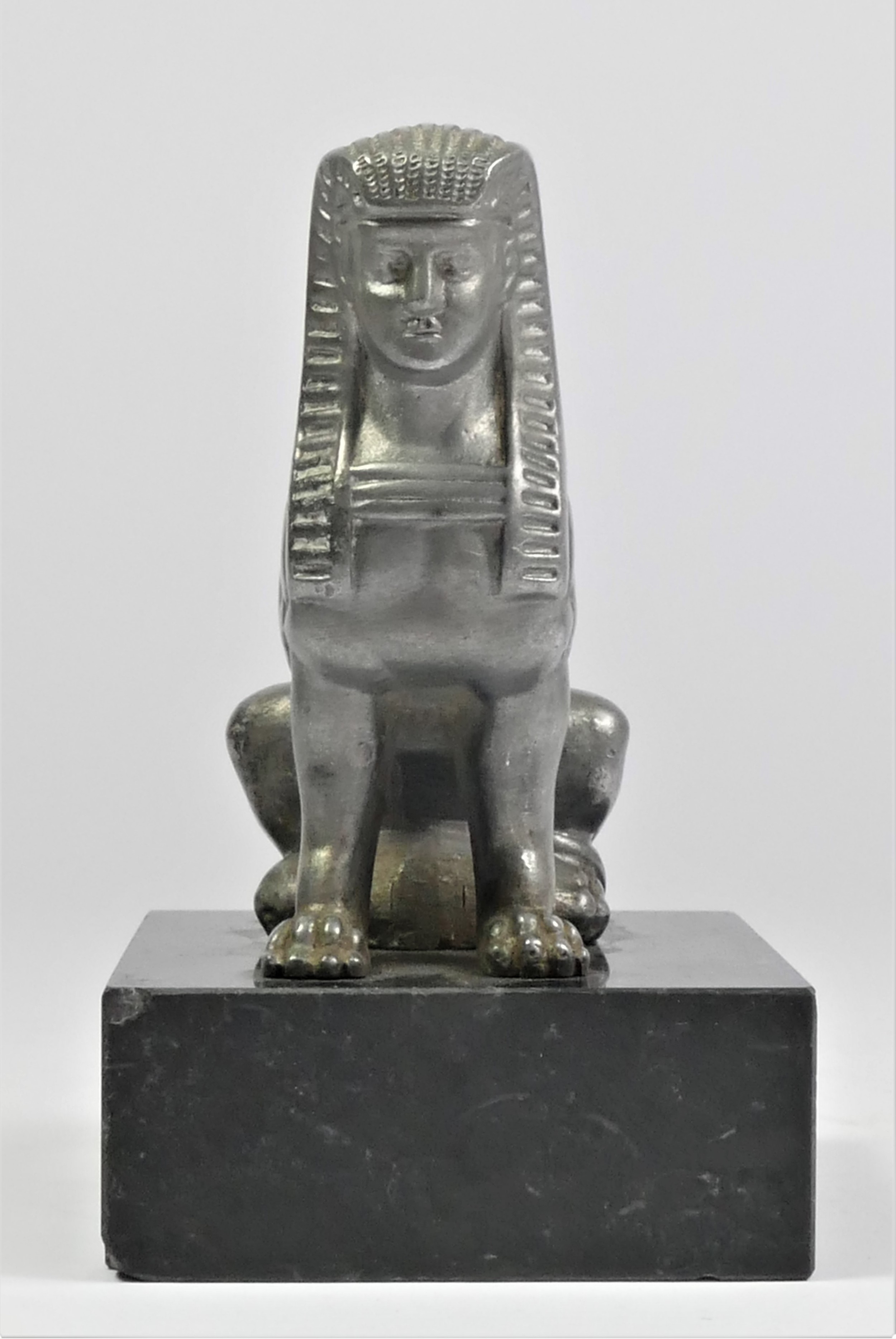 A base metal car mascot in the form of a seated Sphynx mounted on a black onyx base, 11cm. - Image 2 of 2