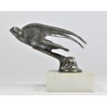 A chrome car mascot in the form of a flying swift mounted on a white onyx base, 10cm.