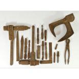 A collection of drilling and riveting ship builders tools, including drill bits and tongs. Used by