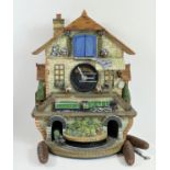 A limited edition Flying Scotsman electric cuckoo clock, made from ceramic and painted resin,