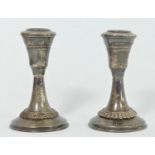 A small silver pair of desk candlesticks, stamped 925, 8cm, loaded