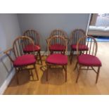 A set of six stick back dining chairs (two carvers), stained, together with four modern pine