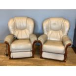 A cream leather three piece suite comprising of a three seater sofa, an electric reclining