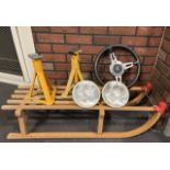 A Gloco German made wooden sledge together with, two axle stands, a pair of headlights and a