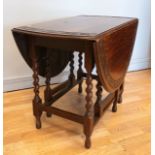 Late 19th/early 20th Century oval drop-leaf gateleg dining table, having carved border to the top,