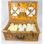 A 1960s/70s Brexton picnic set, rattan wicker picnic basket with fitted utensils, unused.