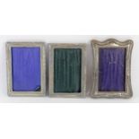 Three silver photograph frames, Birmingham 1925, 17 x 13cm, 1916 and 1914 (the last lacking easel