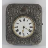 An Edwardian silver easel watch case, Chester 1906 with embossed decoration, with a metal Goliath