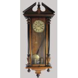 A Victorian Vienna twin weight wall clock, the walnut and ebonised case enclosing the 8" white